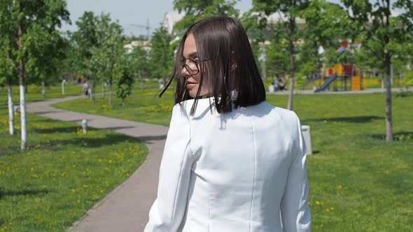 Stylish Woman Walking on Path in Park