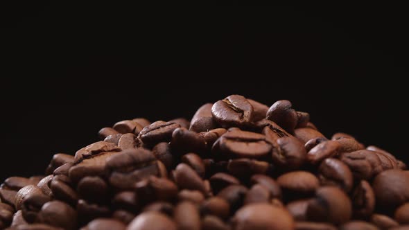 Whole and Ground Coffee Beans on Black Background