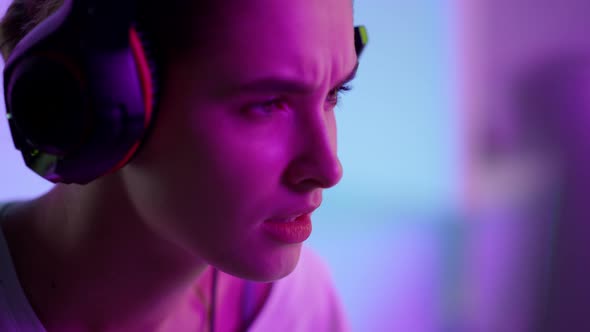 Focused Cyber Girl Playing Computer Game in Headset Closeup