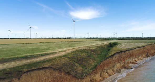 Group of windmills for electric power production on the shore of the sea