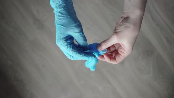 Man Wearing Single Use Medical Face Mask and Gloves