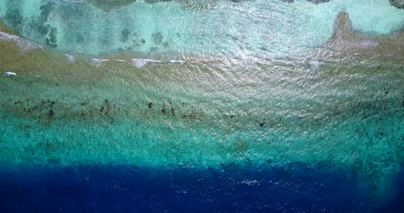 Beautiful fly over abstract view of a white sandy paradise beach and blue water background in colour