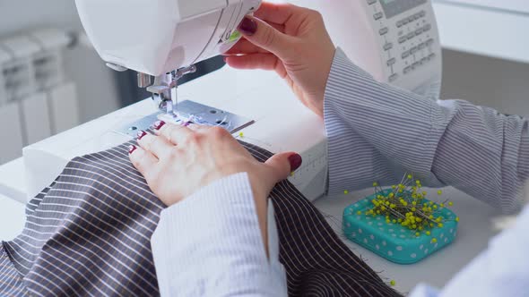 Seamstress Woman Works on Sewing Machine