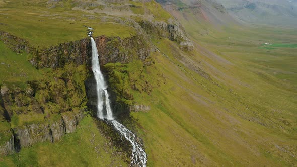 Aerial Drone Footage of Bjarnarfoss Waterfall with Its Green Cliffs in Western Iceland