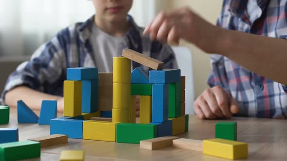 Father and Son Playing With Toy Cubes, Building Small House, Great Time Together