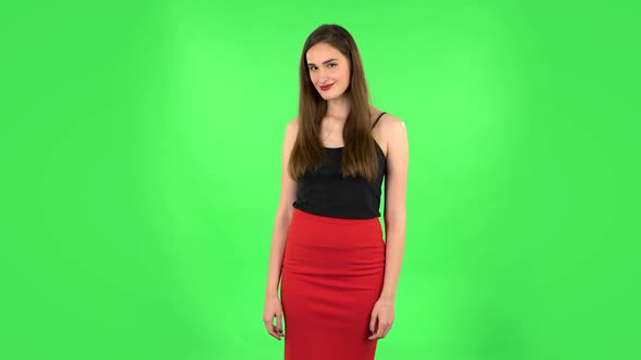 Lovely Girl Smiles Broadly and Winks Flirting. Green Screen