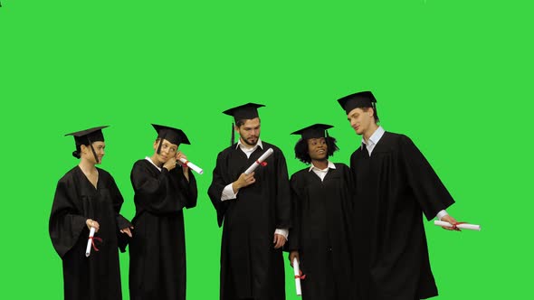 Graduation Students in Robes Preparing for a Group Picture on a Green Screen Chroma Key