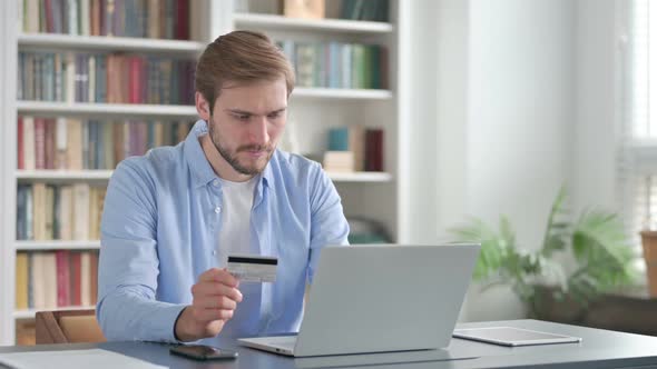 Man Making Online Payment Failure on Laptop in Office