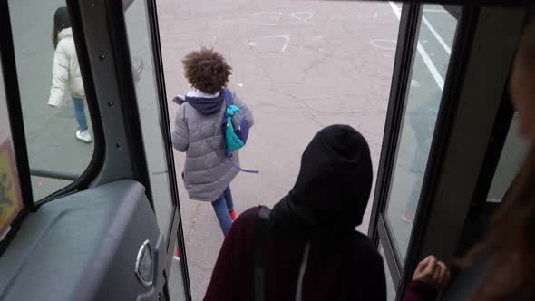 Masked Multiethnic Teens Getting Off School Bus