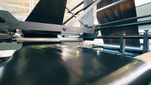 Polyethylene Film Is Rolling Through the Spinning Conveyor