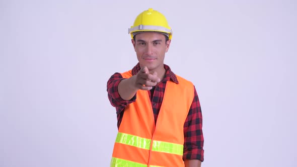 Young Happy Hispanic Man Construction Worker Pointing at Camera