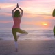 Woman Doing Yoga on Wooden Walkway at Summer Sunset - VideoHive Item for Sale