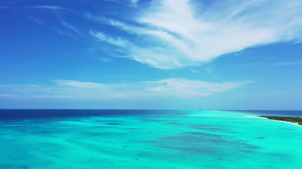 Wide angle drone copy space shot of a sandy white paradise beach and turquoise sea background in hig