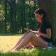 Young Woman In Park Uses Tablet - VideoHive Item for Sale