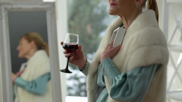 Side View of Unrecognizable Crying Woman Holding Photo Drinking Red Wine at Home