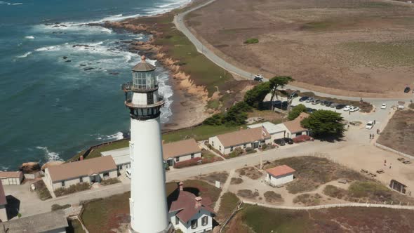 Aerial rotating around Pigeon Point Lighthouse with the blue Pacific Coast in the background ear Hal