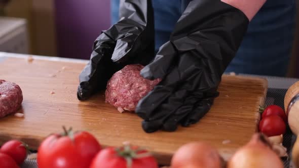 Woman Beats Minced Meat for Cooking Cutlets on Wooden Cutting Board