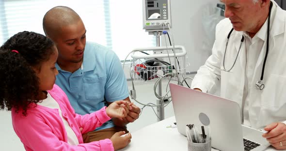 Male doctor checking patient blood pressure