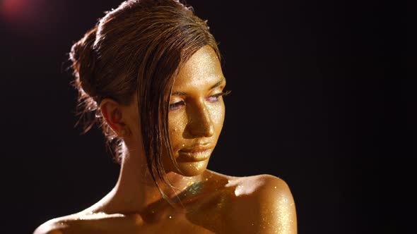Young Woman with Gold Makeup