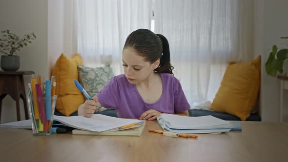 Frustrated young girl trying and failing to prepare homework for school