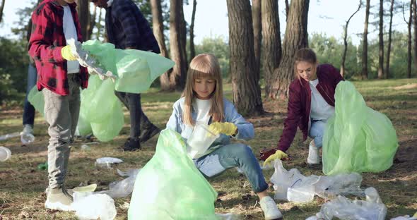 Children and Multiracial Adults-Members of Nature Lovers Charity which Cleaning Park