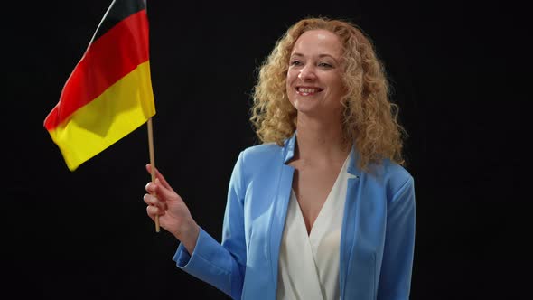Portrait of Charming Confident Politician Holding German Flag Waving Looking Around in Camera