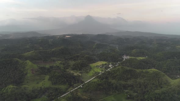 Green Deciduous Tropic Forest at Hill with Grassy Meadows at Mayon Volcano Backdrop