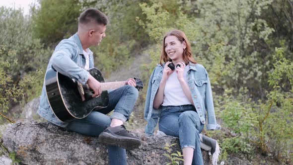 Man Plays Song for Girlfriend on Romantic Date in Forest