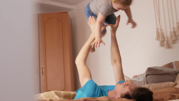 Dad and Daughter Play in Bedroom Happy Family on Bed