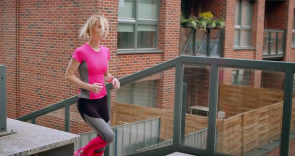 Young Fit Woman Jogging on the Stairs in the City