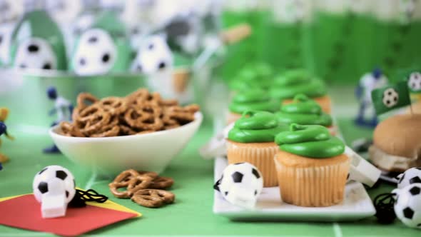 Kids football party set with snacks and drinks.