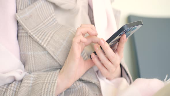 Woman is sitting and looking at phone