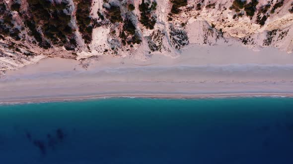 Drone view of scenic beach with white sand and turquoise sea, Greek islands.