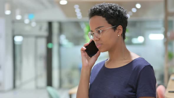 Portrait of Angry Casual African Woman Talking on Smartphone