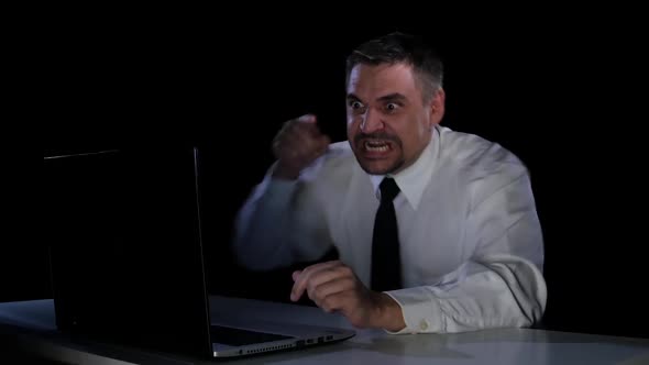 Emotions Rage. A Man Sitting at His Laptop in Anger