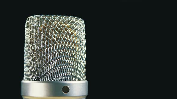 Studio Condenser Microphone Rotates on a Black Background