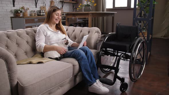 Laughing Handicapped Woman Watching Video at Home