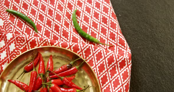 Red chilies in plate on table cloth 4k