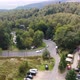 Sports cars driving on sharp bending highway in czech forests, drone. - VideoHive Item for Sale