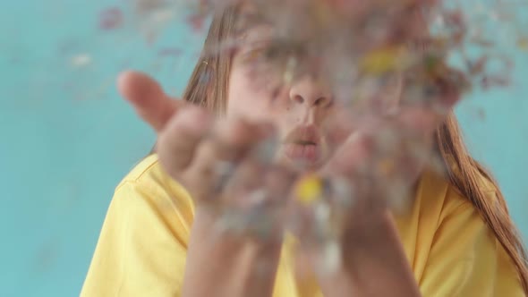 Girl Blowing Sparkles on Camera