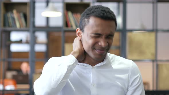 Tired Black Man in Office with Neck Pain