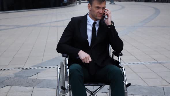 Disabled Invalid Businessman Talking By Phone