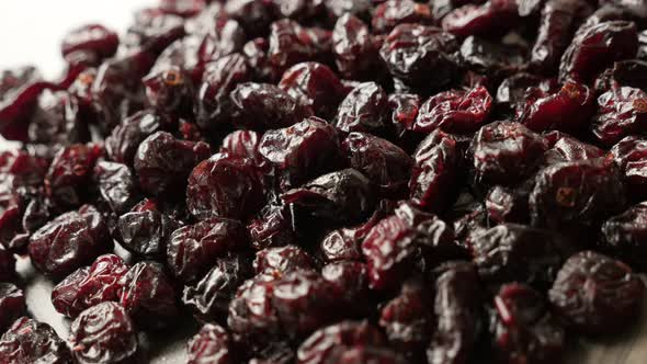 Red organic  cranberries on table 4K 2160p 30fps UltraHD panning footage - Shallow DOF dried berries