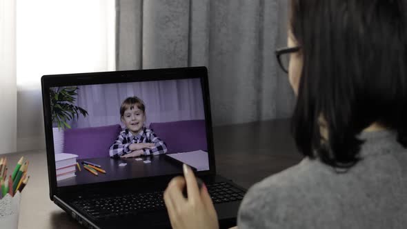 Woman Teacher Makes Video Call on Laptop with Children Pupil. Distance Education