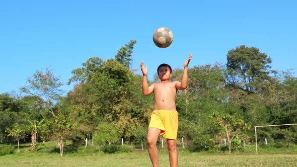 Rural Boy Practice Soccer In Field