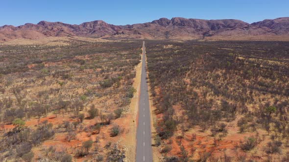 Desert road aerial in Australia outback near West MacDonnell National Park, Alice Springs, Northern