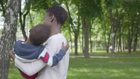 Beautiful African American Woman Spinning Her Son in Her Arms