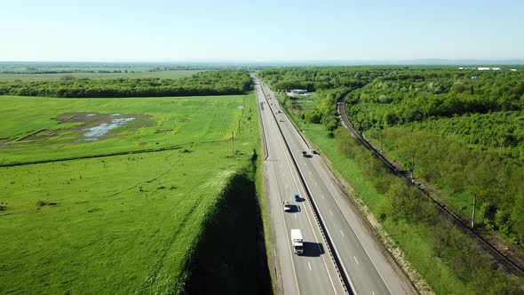 Aerial View of Cars and Truck Drive Along the Highway
