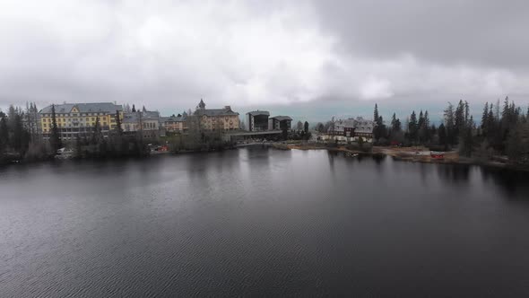 Aerial View of Strbske Pleso, Slovakia. Mountain Lake in Clouds and Snowy Tatras Mountains