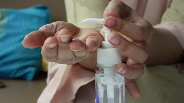 Young Women Using Hand Sanitizer with Copy Space